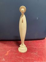 Full view of carved wooden Madonna statue front profile