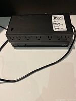 Front angled view showing seven outlets and attached cord