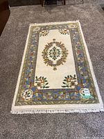 Full view of rug on floor showing size and design