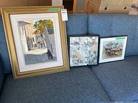 All three framed artworks on couch