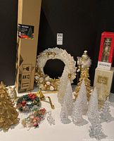 Full lot showing boxed Noma tree, wreath, nutcrackers, gold trees, clear acrylic trees, sleigh and mini wreath