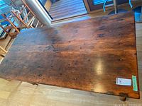 Top view of rectangular wooden harvest table showing plank surface and patina
