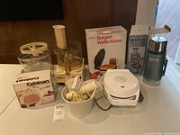 Overall lot showing food processor, waffle maker box, Stanley thermos and boxes