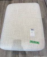 Top view showing light fabric texture and measurement tag