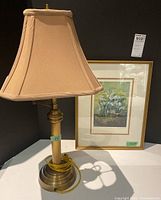 Lamp with shade and framed print side by side