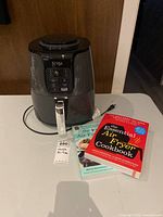 Front view of Ninja air fryer with two cookbooks