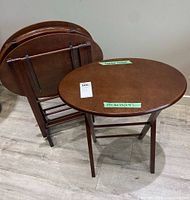 two tables unfolded, two folded in stand showing overall appearance