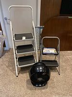 Three items together: three-step ladder, two-step stool, floor fan