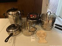 Group shot of all cookware pieces and board