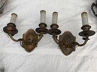 Front view of both brass two-arm sconces