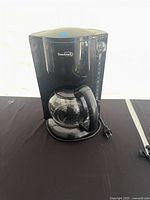 Front view of Beaumark coffee maker showing carafe and body