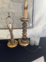 Both brass lamps and two glass candle holders