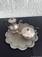 Full view of coffee pot, teapot, and brass tray