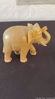Left side view of carved stone elephant figurine