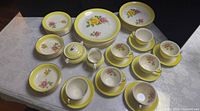 Full view of 46-piece yellow rim rose pattern china set