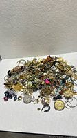 Overall pile of assorted jewelry pieces on tabletop