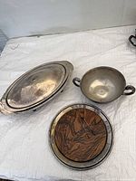 Overall lot showing covered dish, tray with wood insert, two-handled bowl