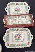 Boxed set showing cups, saucers and trays together