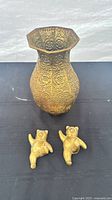 Brass vase and two bear wall hangings overall view