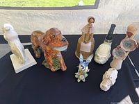 Group shot of all nine ceramic pieces on black cloth