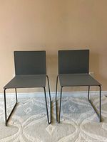 Front view of both grey sled-base chairs