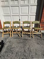 front view of four wood folding chairs