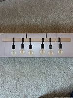 Front of sealed box showing five-light pendant design