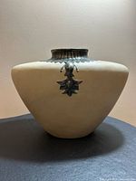 front view of handmade ceramic vase showing body shape and metallic motif