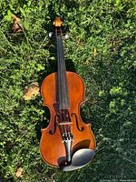 Front view of full size violin with chinrest and bridge