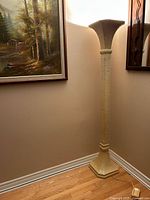 Full view of torchiere floor lamp standing in corner