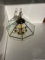 Top view of octagonal brass and glass chandelier showing wiring and socket arrangement
