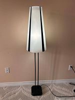 Full view of IKEA Vistofta floor lamp standing on floor showing complete form