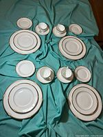 Full layout of four 5-piece settings on teal cloth