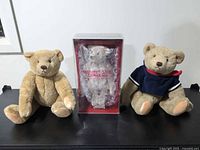 Group shot of three teddy bears including boxed Steiff and two loose bears