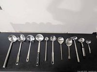 Group shot of 11 kitchen utensils laid out in a row