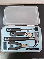 Closed clear-lid case holding all TRIXIG tools