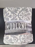 Front view of factory-wrapped Life Comfort Moderne plush throw blanket
