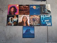 Group shot of all nine LPs laid out on floor