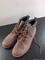 Front/side view showing overall appearance, laces, toe scuffs