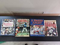 Front covers of all four sports history paperbacks laid out side by side
