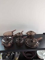 All six cookware bodies with five lids displayed
