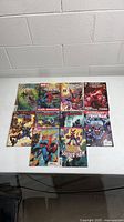 Overhead image showing all ten Spider-Man related Marvel comic books laid out on a table