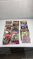 All 21 Marvel comic books laid out showing visible titles and cover art.
