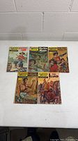 Five Classics Illustrated comics spread on table showing front covers