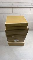 Stack of five Michael Kors shoe boxes
