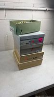 Stack of five shoe boxes, worn, Artisan Collection box open