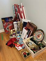 Overall lot showing wrapping paper rolls, bags, cards, ribbon, trays