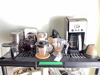 Overview of all coffee and tea preparation items on shelf