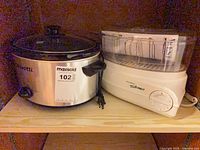 Bravetti slow cooker and West Bend steamer side by side on shelf