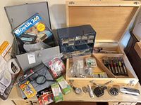 Overall lot view showing glue gun case, wooden toolbox, blue drawer organizer, packaged items